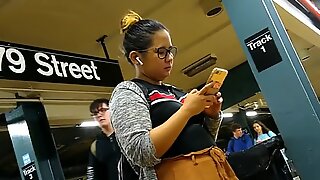 Cute chubby Filipina girl with glasses waiting for train